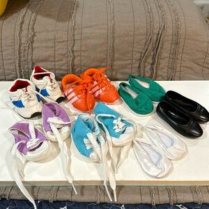 Seven pair of doll shoes will fit American doll